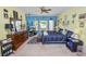Bright main bedroom with ample natural light, complemented by a ceiling fan and neutral carpet at 181 James Cir, Lake Alfred, FL 33850