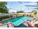Screened-in pool area featuring clear blue water, with a waterfall and lounge seating at 181 James Cir, Lake Alfred, FL 33850