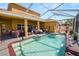 A serene, screened-in swimming pool surrounded by lounge furniture and lush landscaping at 181 James Cir, Lake Alfred, FL 33850