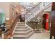 Open staircase with carpeted steps, white railings, and walls adorned with decorative art at 181 James Cir, Lake Alfred, FL 33850