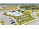 Aerial view of a community pool, playground, and dog park surrounded by modern single-Gathering homes at 2983 Flying Blackbird Rd, Bartow, FL 33830