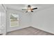 Bright bedroom with neutral carpet, a ceiling fan, and a window with horizontal blinds at 2983 Flying Blackbird Rd, Bartow, FL 33830