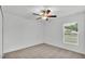 Bright bedroom with neutral carpet, a ceiling fan, and a window with horizontal blinds at 2983 Flying Blackbird Rd, Bartow, FL 33830