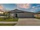 Charming single-story home featuring a well-manicured lawn, two-car garage, and neutral gray color scheme at 2983 Flying Blackbird Rd, Bartow, FL 33830