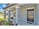 Inviting front porch with decorative columns, a cozy seating area, and a 'No Soliciting' sign at 2983 Flying Blackbird Rd, Bartow, FL 33830