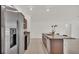 Kitchen featuring an island, granite countertops, stainless steel appliances, and brown cabinets at 2983 Flying Blackbird Rd, Bartow, FL 33830