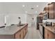 Kitchen featuring an island, granite countertops, stainless steel appliances, and brown cabinets at 2983 Flying Blackbird Rd, Bartow, FL 33830