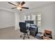 Bright office space featuring a ceiling fan, desk, and a dual monitor setup near a window at 2983 Flying Blackbird Rd, Bartow, FL 33830