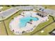 Aerial view of a clover-shaped community pool featuring palm trees, lounge chairs, and a covered seating area at 2983 Flying Blackbird Rd, Bartow, FL 33830