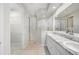 Bright bathroom with double vanity, granite countertop, glass shower, and walk-in closet at 2997 Mission Lakes Dr, Lakeland, FL 33803