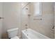 Well-lit bathroom featuring tiled shower, a bathtub, and safety bars at 2997 Mission Lakes Dr, Lakeland, FL 33803