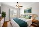 Bedroom with hardwood floors, white shutters, ceiling fan, and soft, natural light at 2997 Mission Lakes Dr, Lakeland, FL 33803