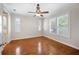 Spacious bedroom featuring hardwood floors, white walls, and plantation shutters at 2997 Mission Lakes Dr, Lakeland, FL 33803