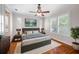 Bright bedroom featuring hardwood floors, white plantation shutters, and a cozy rug at 2997 Mission Lakes Dr, Lakeland, FL 33803