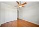Bedroom with hardwood floors, ceiling fan, and a closet with bi-fold doors at 2997 Mission Lakes Dr, Lakeland, FL 33803
