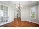 Dining room with hardwood floors, a chandelier, and a glass-paneled door at 2997 Mission Lakes Dr, Lakeland, FL 33803