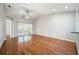 Bright, airy living room with hardwood floors and sliding glass doors to let in the light at 2997 Mission Lakes Dr, Lakeland, FL 33803
