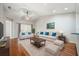 Comfortable living room with vaulted ceiling, ceiling fan, bright furniture, and hardwood floors at 2997 Mission Lakes Dr, Lakeland, FL 33803
