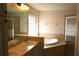 The bathroom features dual sinks, a glass block window, a glass shower, and a soaking tub at 3817 Osprey Pointe Cir, Winter Haven, FL 33884