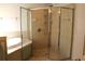 The bathroom features a glass shower with tile surround and a handheld shower head at 3817 Osprey Pointe Cir, Winter Haven, FL 33884