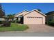 Charming single-story home features a manicured lawn, brick driveway and a two car garage at 3817 Osprey Pointe Cir, Winter Haven, FL 33884