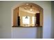 A kitchen pass-through view, showing granite countertops, a ceiling fan, and stainless steel appliances at 3817 Osprey Pointe Cir, Winter Haven, FL 33884