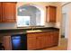 Kitchen area showing view from breakfast bar of under-cabinet sink and black appliances at 3817 Osprey Pointe Cir, Winter Haven, FL 33884