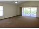 Living room includes a sliding door to the backyard and a ceiling fan at 3817 Osprey Pointe Cir, Winter Haven, FL 33884