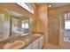 Bathroom showing double sinks, large mirror, separate glass enclosed shower and tub at 4069 Byrds Crossing Dr, Lakeland, FL 33812