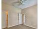 Bedroom with ceiling fan, neutral carpet, and open closet space, providing ample room at 4069 Byrds Crossing Dr, Lakeland, FL 33812