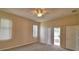 Bright bedroom with a ceiling fan and sliding doors to the patio, offering a comfortable and relaxing space at 4069 Byrds Crossing Dr, Lakeland, FL 33812