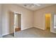 Bright bedroom with open doorways, neutral carpet, and ceiling fan, creating a comfortable living space at 4069 Byrds Crossing Dr, Lakeland, FL 33812