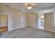 Spacious bedroom boasts neutral carpeting, ceiling fan, and ensuite bathroom access at 4069 Byrds Crossing Dr, Lakeland, FL 33812