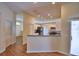 Open-concept kitchen with stainless steel appliances and a breakfast bar looking into the living area at 4069 Byrds Crossing Dr, Lakeland, FL 33812