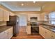 Well-lit kitchen featuring stainless steel appliances, white cabinetry, and a functional layout at 4069 Byrds Crossing Dr, Lakeland, FL 33812