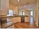 Well-lit kitchen with stainless steel dishwasher, white cabinets, and a breakfast bar perfect for dining and entertaining at 4069 Byrds Crossing Dr, Lakeland, FL 33812