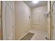 Functional laundry room with tile flooring, white walls, and convenient shelving for storage at 4069 Byrds Crossing Dr, Lakeland, FL 33812