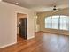 Bright living room with wood floors, large window, and open access to the kitchen at 4069 Byrds Crossing Dr, Lakeland, FL 33812