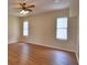 Spacious living room with beautiful laminate floors, a ceiling fan, and plenty of natural light from large windows at 4069 Byrds Crossing Dr, Lakeland, FL 33812