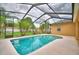 Inviting screened-in pool with clear blue water, surrounded by a spacious deck for lounging and recreation at 4069 Byrds Crossing Dr, Lakeland, FL 33812