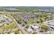 Panoramic aerial view of a townhome community nestled amongst mature trees near a highway at 517 Sandstone St, Lakeland, FL 33809