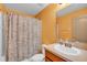 Bathroom features a shower with decorative shower curtain and a vanity sink at 517 Sandstone St, Lakeland, FL 33809