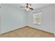 Bedroom has tile flooring, ceiling fan, and ample natural light at 517 Sandstone St, Lakeland, FL 33809