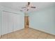 Bedroom featuring tile floors, ceiling fan, and closet at 517 Sandstone St, Lakeland, FL 33809