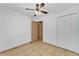 Cozy bedroom featuring a ceiling fan, neutral walls, and tiled floors at 517 Sandstone St, Lakeland, FL 33809