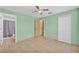 Bedroom includes tile flooring, ceiling fan, and closet at 517 Sandstone St, Lakeland, FL 33809