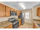 Modern kitchen featuring stainless steel appliances and granite countertops at 517 Sandstone St, Lakeland, FL 33809