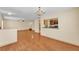 Open-concept living area flows into the kitchen, featuring hardwood floors at 517 Sandstone St, Lakeland, FL 33809