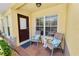 Charming front porch with a cozy seating area and decorative pillows at 5407 River Rock Rd # 5407, Lakeland, FL 33809