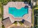 Aerial view of a sparkling community pool surrounded by lounge chairs and lush greenery at 5407 River Rock Rd # 5407, Lakeland, FL 33809